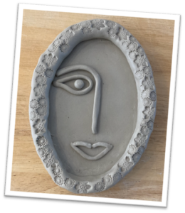 A trinket dish in the stylised shape of a woman's smiling face